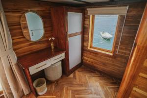 a small room with a mirror and a boat in the water at Komodo Top Sailing in Labuan Bajo +60 photos