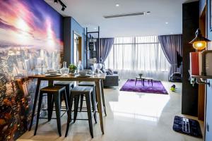 a living room with a table and some chairs at KLCC View Penthouse in Kuala Lumpur