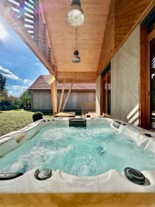 a hot tub in the middle of a house at Soling apartmanház Velence in Velence