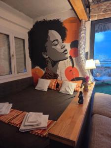 a bedroom with a large mural of a woman at Penthouse studio Lola New Belgrade in Novi Beograd