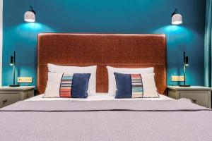 a bedroom with a large bed with two pillows at La Casa Marina Suites & Rooms in Fethiye