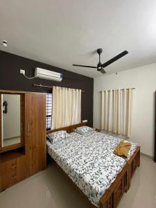 a bedroom with a large bed and a mirror at 3BHK AC Villa with Attached Baths in Trivandrum