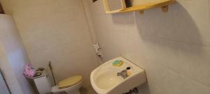 a small bathroom with a toilet and a sink at Babazia Community in Pai +81 photos