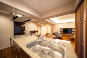 a kitchen with a sink and a living room at 御屋 清水紫翠庵 in Kyoto +95 photos