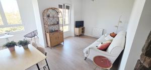 a living room with a white couch and a table at Sand House Gorliz By Kima Gestión in Górliz-Elexalde