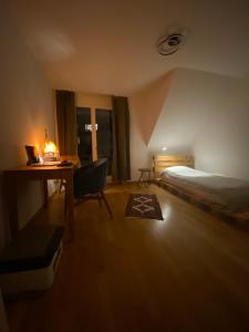 a bedroom with a bed and a desk and a bed and a table at Your home in Zug - Room and private bathroom in lakefront shared apartment in Zug