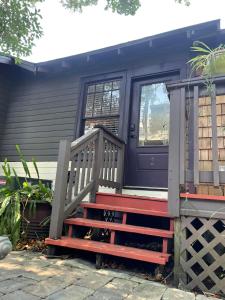 a front door of a tiny house with a bench at Old Town "Cincinnati" in Saint Augustine