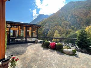 a house with a balcony with a view of a mountain at Hotel Hani in Peje