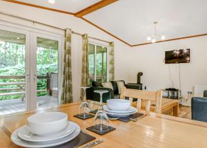 a dining room with a table with dishes on it at Quarry Walk Lodges in Cheadle