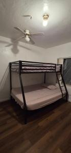 a bunk bed in a room with a ceiling fan at HolydayPalmBeachPoolHouse99fourPersonamin3 to5PersPartyPerBedroom in Lake Worth +7 photos