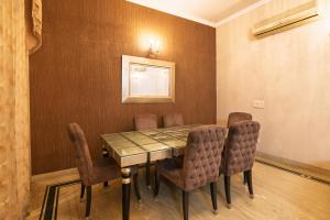 a dining room with a table and chairs at Luxury HomeStay Prime Location, South Delhi in New Delhi