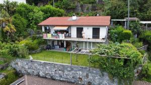 an aerial view of a house with a stone wall at A nice view, panorama over Lago Maggiore in Ronco sopra Ascona