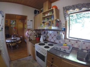 a small kitchen with a stove and a table at A nice view, panorama over Lago Maggiore in Ronco sopra Ascona