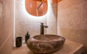 a bathroom with a large stone sink on a counter at le cocon du beffroi centre ville in Millau +15 photos