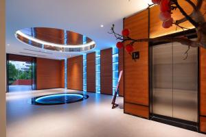 a lobby with a circular ceiling and a glass door at Lucky house in Gaotian