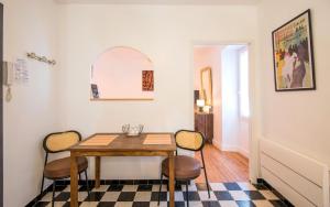 a dining room with a table and chairs at le cocon du beffroi centre ville in Millau