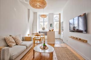 a living room with a couch and a table at Le Saint-Sauveur - Balneotherapy Bathtub - Hypercentre in Caen