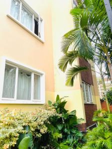 a building with a palm tree in front of it at Tranquility Homes in Durban