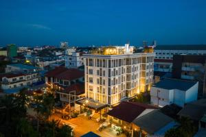 a large white building in a city at night at S 2 Modern Boutique Hotel in Vientiane