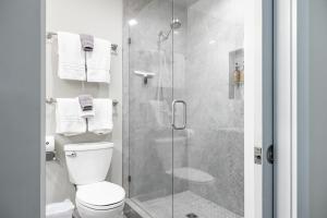 a bathroom with a toilet and a glass shower at The Cove Retreat- Hot Tub/Screened Porch/Game Room in Lake Lure +23 photos