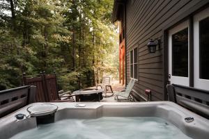 a hot tub on the side of a house at The Cove Retreat- Hot Tub/Screened Porch/Game Room in Lake Lure