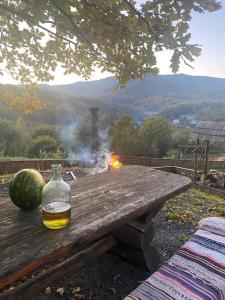 a bottle of alcohol sitting on a wooden table with a fire at Панорама Шаян in Shaian