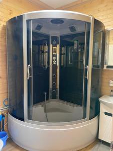 a shower in a bathroom with a glass wall at Панорама Шаян in Shaian