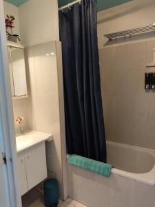 a bathroom with a shower with a black shower curtain at Conciergerie de la Côte in Banyuls-sur-Mer