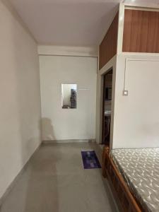 a bedroom with a bed and a painting on the wall at Eden homes in Honāvar