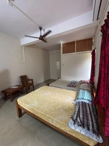 a bedroom with a bed and a ceiling fan at Eden homes in Honāvar