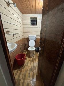 a small bathroom with a toilet and a sink at Eden homes in Honāvar