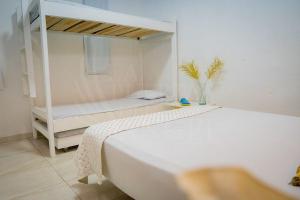 a bedroom with a bed and a bunk bed at La Puerta del Ángel LOW COST in Ricaurte