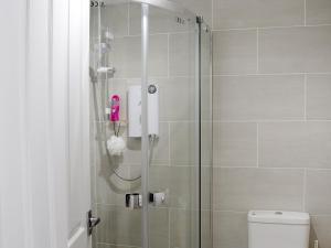 a bathroom with a shower with a glass door at 1 Greta Side Court in Keswick