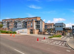 an empty parking lot in front of a building at Nat's Villa in Midrand
