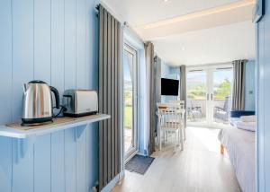 a room with a bed and a kitchen with a microwave at South View Retreat in Carlton