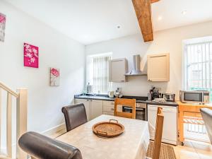 een keuken met een tafel en stoelen in een kamer bij Shire Cottage - Uk37451 in Pateley Bridge