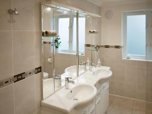 a bathroom with two sinks and a shower at The Nest in Aldringham
