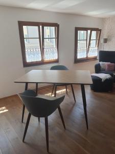 a living room with a table and a chair at FeWo Sonne in Konstanz