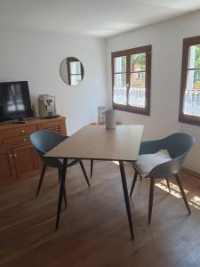 a table and two chairs in a living room at FeWo Sonne in Konstanz