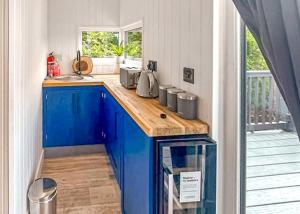 a kitchen with blue cabinets and a counter top at Watermill Leisure Park in Moortown