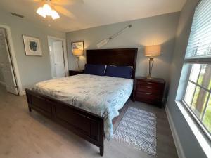 a bedroom with a large bed and a window at Tarpon - Spacious Updated W&D Full Kitchen 1.5 Mi to Beach in Bonita Springs