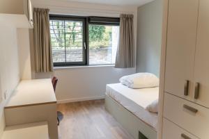 a bedroom with a bed and a window at Destiny - Burnet Point in Edinburgh