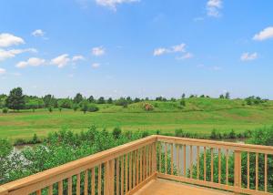 a wooden deck with a view of a field at Kingswood Golf Lodges in Thorne