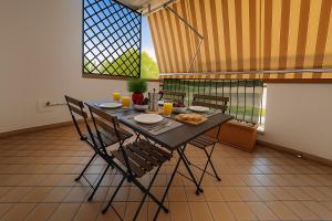 a dining room with a table and chairs and a window at Civico 44 in Ravenna