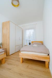 a bedroom with a bed and a large white cabinet at Schöne, zentral gelegene &renovierte Wohnung in NR in Neuwied