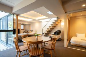 a room with a bed and a table and chairs at 御屋 清水紫翠庵 in Kyoto