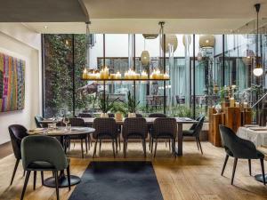 a dining room with a table and chairs at Balthazar Hotel & Spa Rennes - MGallery Collection in Rennes