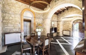 a dining room with a table and a chandelier at Gorgeous Home In Ragusa in Ragusa