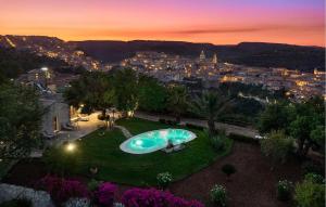 Una piscina en un patio con una ciudad de noche. en Pet Friendly Home In Ragusa, en Ragusa 15 fotos más