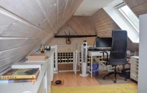 an attic room with a desk and a computer in it at 3 Bedroom Cozy Home In Hammenhög in Västanbäck